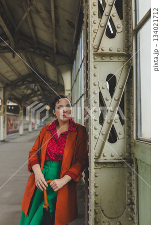 Woman brunette waiting on vintage train platform Woman brunette waiting on vintage train platform 134021712