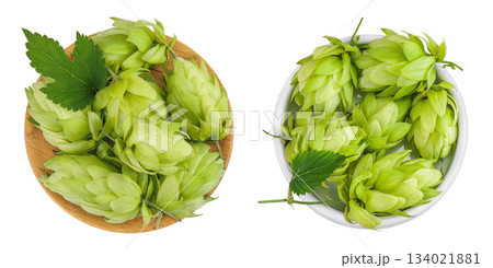 Hop cones in wooden and ceramic bowl isolated on white background. Beer brewing ingredients. Top view. Flat lay Hop cones in wooden and ceramic bowl isolated on white background. Beer brewing ingredients. Top view. Flat lay 134021881