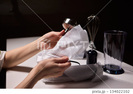 Preparing blender on kitchen counter, Scene shows detailed process of assembling immersion blender, Cozy kitchen scene of hands carefully putting together blending device 134022102
