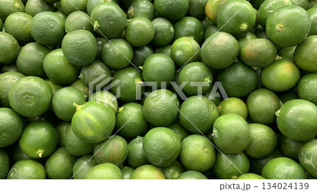 Top view of small limes display in a wet market with customizable space for text. Top view of small limes display in a wet market with customizable space for text. 134024139