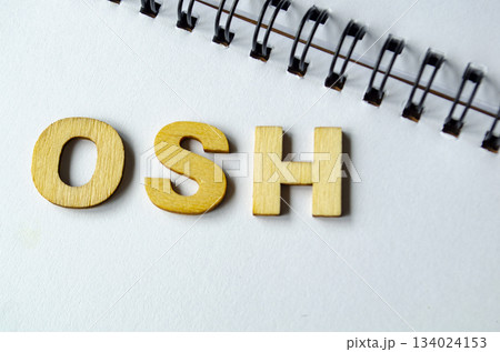OSH representing Occupational Health and Safety on white notepad. 134024153