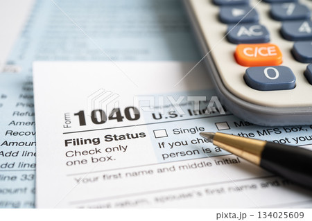 Tax Return form 1040 and dollar banknote, U.S. Individual Income. Tax Return form 1040 and dollar banknote, U.S. Individual Income. 134025609