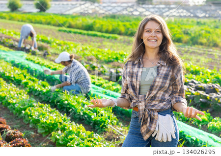 Young woman posing in field among harvest Young woman posing in field among harvest 134026295