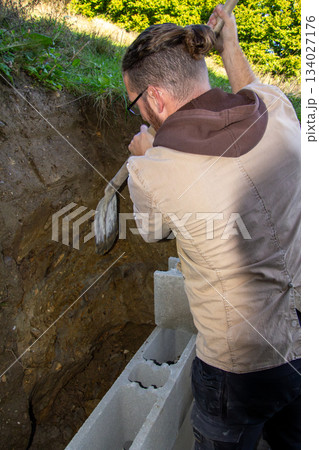 Building a fundamental brick wall in a mountain. Building a fundamental brick wall in a mountain. 134027176