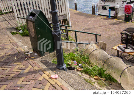 Catching garbage in a garbage bin or in a fishing net. 134027260