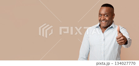 Life is good. Happy mature african american man gesturing thumb up on camera, orange studio background 134027770