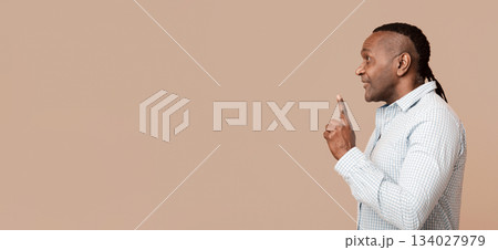 Mature african american man having idea, pointing finger up, got problem solution, profile portrait Mature african american man having idea, pointing finger up, got problem solution, profile portrait 134027979