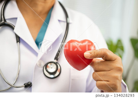 Asian woman doctor holding red heart for health in hospital. 134028293