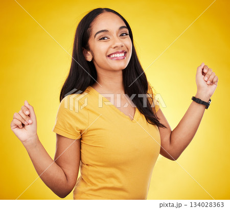 Happy, young and portrait of a beautiful woman isolated on a yellow background in a studio. Casual, smile and a gorgeous girl looking cheerful, cute and fashionable in a bright shirt on a backdrop Happy, young and portrait of a beautiful woman isolated on a yellow background in a studio. Casual, smile and a gorgeous girl looking cheerful, cute and fashionable in a bright shirt on a backdrop 134028363