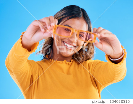 Fashion sunglasses, happy portrait and woman face with clothes, designer brand or casual outfit style. Gen z summer aesthetic, trendy studio glasses and young female model on blue background 134028510