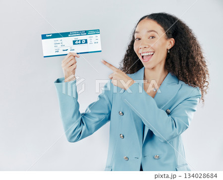 Business woman, plane ticket and portrait pointing for international travel or boarding pass against white studio background. Happy female traveler smiling for global trip, flight booking or document Business woman, plane ticket and portrait pointing for international travel or boarding pass against white studio background. Happy female traveler smiling for global trip, flight booking or document 134028684