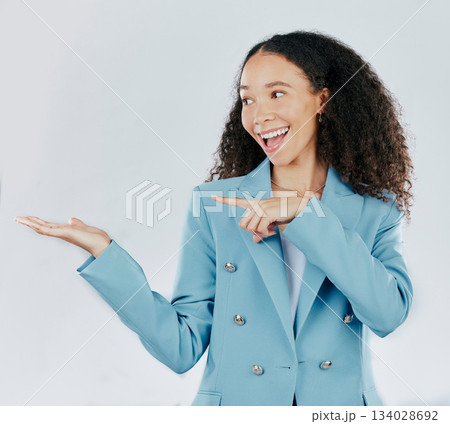 Business woman, pointing and studio with palm for mockup, promotion or space by white background. Happy entrepreneur, smile and open hand for product placement, mock up or happiness for company promo 134028692