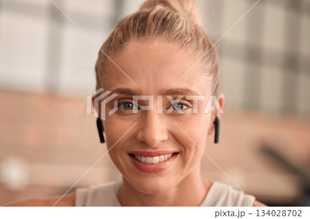 Woman, face and happy in gym, earpods and listening to music for motivation to exercise with portrait and fitness. Health, active lifestyle and headshot with radio streaming, wifi and workout mockup 134028702