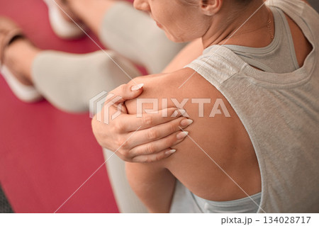 Shoulder injury, woman and pain in gym from exercise, medical emergency and injured muscle, problem and above. Closeup female, arm and sports accident from workout, first aid and fitness health risk 134028717