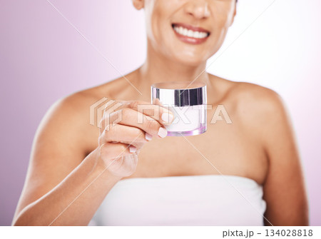 Hands, cream jar and woman smile in studio isolated on purple background. Face skincare, dermatology cosmetics and happy female holding lotion container, creme or moisturizer product for skin health. Hands, cream jar and woman smile in studio isolated on purple background. Face skincare, dermatology cosmetics and happy female holding lotion container, creme or moisturizer product for skin health. 134028818