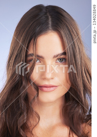 Woman, beauty and hair or face portrait in studio for curls, growth and shine on blue background. Aesthetic female model smile for haircare, self care and cosmetic for salon or hairdresser treatment 134028849