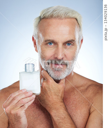 Old man, portrait and confident, face with cologne and grooming, hygiene and parfum product on studio background. Perfume, fresh fragrance and anti aging cosmetic care, senior male and skincare 134029136