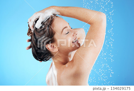 Shampoo, washing hair and smile, woman in shower on blue background for morning bathroom routine in studio mockup. Healthy haircare, water and happiness for happy beauty model cleaning in soapy foam. Shampoo, washing hair and smile, woman in shower on blue background for morning bathroom routine in studio mockup. Healthy haircare, water and happiness for happy beauty model cleaning in soapy foam. 134029175