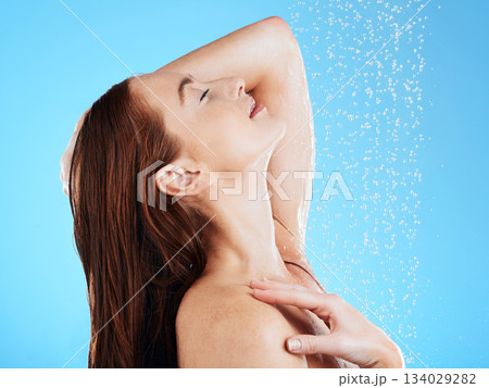 Shower, water and calm woman in studio, blue background and cleaning for hygiene, wellness and fresh routine. Happy female model washing with wet drops for beauty, skincare and grooming for self care Shower, water and calm woman in studio, blue background and cleaning for hygiene, wellness and fresh routine. Happy female model washing with wet drops for beauty, skincare and grooming for self care 134029282