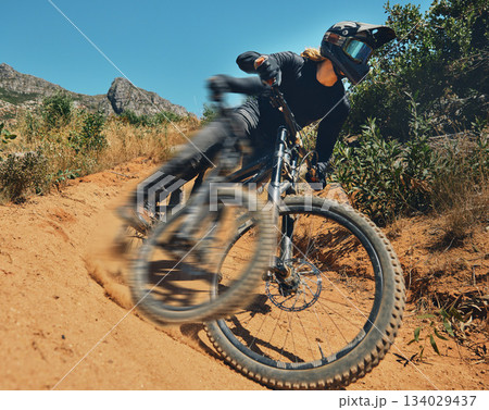 Cycling, fast and extreme sports with man on mountain bike for adventure, fitness and adrenaline junkie. Exercise, risk and motion blur with male athlete in nature for workout, training and speed 134029437