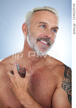 Senior man, cologne bottle and smile in a studio with a male model and perfume spray. Happy, skincare and elderly person doing dermatology, beauty and body care smell routine with grey background Senior man, cologne bottle and smile in a studio with a male model and perfume spray. Happy, skincare and elderly person doing dermatology, beauty and body care smell routine with grey background 134029549