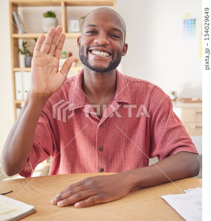 Wave, video call and portrait of black man in office for conference, communication and networking. Hello, greeting and online meeting with male in startup agency for virtual, friendly and webinar Wave, video call and portrait of black man in office for conference, communication and networking. Hello, greeting and online meeting with male in startup agency for virtual, friendly and webinar 134029649