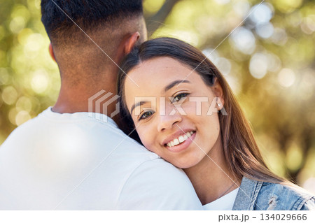 Love, hug and shoulder with couple in park for bonding, affectionate and free time. Happiness, date and smile with portrait of woman hugging man in nature for relax, summer and romance on vacation 134029666