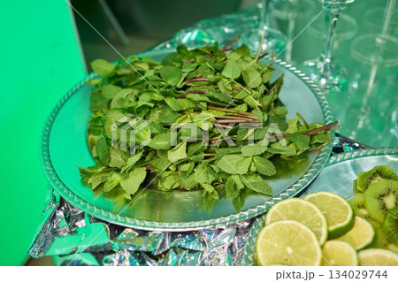 Fresh citrus and tropical slices, Vibrant arrangement of fruits on reflective surface, Exquisitely layered citrus and tropical fruits showcased for festive presentation 134029744
