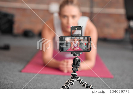 Live streaming, fitness and phone of woman exercise, pilates or workout on social media or video platform on tripod. Gen z athlete, sports influencer or content creator training on smartphone screen 134029772