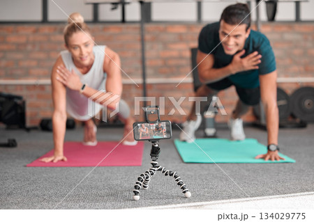 Live streaming, phone fitness and people in exercise teamwork, workout and social media video on tripod. Happy athlete training, influencer couple of friends or sports content creation on smartphone 134029775