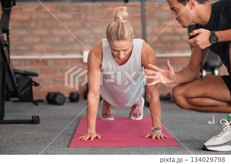 Fitness, push up and people, personal trainer or woman in gym coaching for support, performance check and muscle goals. Athlete, sports person in strong workout, exercise motivation or training timer 134029798
