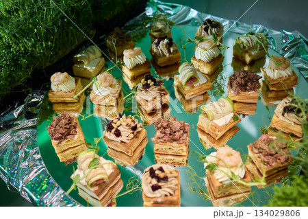 Elegant mushroom appetizer display, Serving tray featuring mushroom inspired treats, Artfully arranged decorative tray with creamy mushroom topped toasted bread slices 134029806