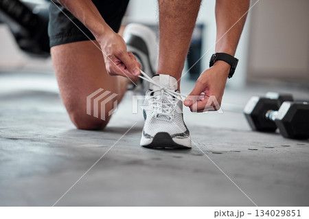 Fitness, hands and tie shoes in gym to start workout, training or exercise. Sports, athlete and man tying footwear or sneakers to get ready or prepare for running, cardio or exercising for health. 134029851
