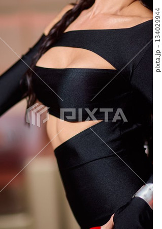 Elegant confident woman, Stylish woman showcases fashionable attire at sophisticated gathering, Fashionably dressed woman with braided hair exudes confidence at classy 134029944