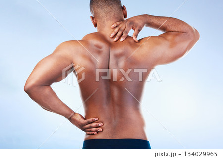 Black man, neck pain and back injury with fitness and health, medical problem and aching body in studio. Emergency, muscle tension and male athlete with joint ache from workout on blue background 134029965