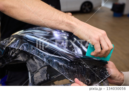 Applying a Protective Film on the Surface of Your Car for Enhanced Durability and Shine Applying a Protective Film on the Surface of Your Car for Enhanced Durability and Shine 134030056