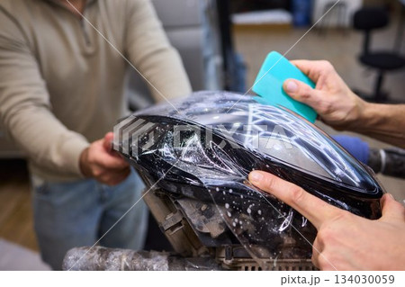 Applying a Protective Film on the Surface of Your Car for Enhanced Durability and Shine Applying a Protective Film on the Surface of Your Car for Enhanced Durability and Shine 134030059