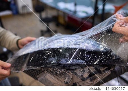 Applying a Protective Film on the Surface of Your Car for Enhanced Durability and Shine 134030067