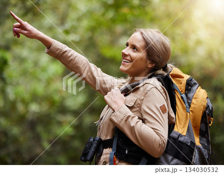 Hiking, pointing or happy woman in nature, forest or wilderness for a trekking adventure. Freedom, backpack excited female hiker walking in a natural park or woods for exercise or wellness on holiday 134030532