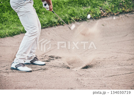 Golf course, man and swing in sand pit for shot, sports and training for hazard with power, aim and fitness. Golfer, bunker and dirt with club with sport, exercise and outdoor mockup space in summer Golf course, man and swing in sand pit for shot, sports and training for hazard with power, aim and fitness. Golfer, bunker and dirt with club with sport, exercise and outdoor mockup space in summer 134030719