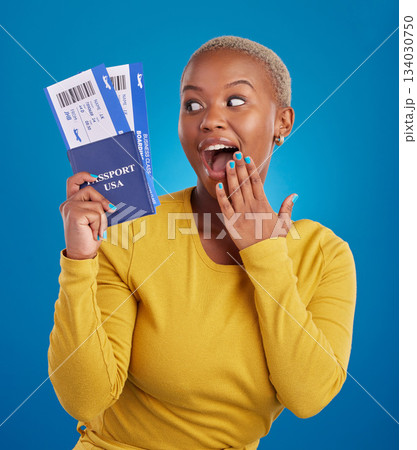 Surprise, travel passport and black woman in studio on blue background with flight documents, tickets and ID. Traveling mockup, happy and girl celebrate immigration, USA holiday and global vacation 134030750