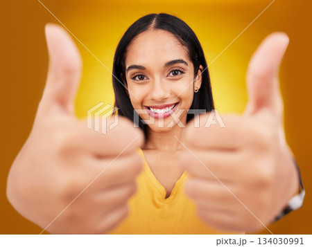 Thumbs up, portrait and hands of happy woman in studio, excited winner and bonus on background. Female model, thumb and smile to celebrate winning achievement, like emoji and support, yes or feedback Thumbs up, portrait and hands of happy woman in studio, excited winner and bonus on background. Female model, thumb and smile to celebrate winning achievement, like emoji and support, yes or feedback 134030991