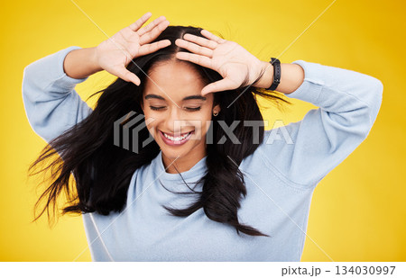 Happy, freedom and calm with a woman on a yellow background in studio feeling carefree or cheerful. Smile, relax and relief with an attractive young female posing eyes closed in a peaceful mood 134030997
