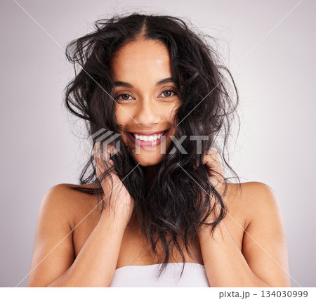 Hair care, woman and beauty with portrait, cosmetics and happy with messy hairstyle on studio background. Wellness, shine and female smile, face and treatment, keratin and texture with volume 134030999