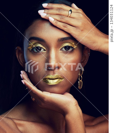 Indian woman, art makeup and studio portrait for beauty, wellness or celebration by black background. Model face, asian girl and dark aesthetic with gold lipstick, jewellery or cosmetic for a queen 134031124