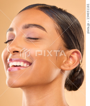Beauty face, skin and smile of woman in studio for skincare, cosmetics, dermatology or makeup. Aesthetic female .headshot for self care, natural skin and spa facial shine results on brown background Beauty face, skin and smile of woman in studio for skincare, cosmetics, dermatology or makeup. Aesthetic female .headshot for self care, natural skin and spa facial shine results on brown background 134031181