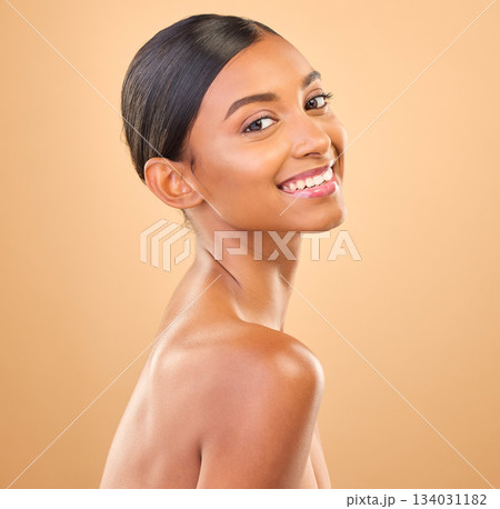 Face, beauty and smile portrait of woman in studio for skincare, cosmetics, dermatology or makeup. Aesthetic female happy for self care, natural skin or spa facial shine results on a brown background 134031182