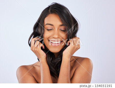 Woman, smile and curly hair for salon treatment, keratin or self care against a white studio background. Happy isolated female model smiling in satisfaction for healthy hairstyle, haircare or beauty Woman, smile and curly hair for salon treatment, keratin or self care against a white studio background. Happy isolated female model smiling in satisfaction for healthy hairstyle, haircare or beauty 134031191