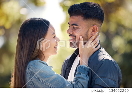 Couple, outdoor and smile for love, care and happiness together in summer. Young woman with hand on face of a man at nature park for affection or trust on happy and romantic date or vacation to relax Couple, outdoor and smile for love, care and happiness together in summer. Young woman with hand on face of a man at nature park for affection or trust on happy and romantic date or vacation to relax 134032299