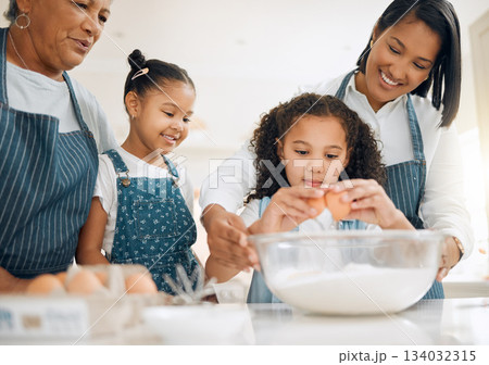Grandmother, mom or kids baking in kitchen as a happy family with young girl learning cookies recipe. Mixing cake, parent or grandma smiling or teaching children to bake with eggs for development Grandmother, mom or kids baking in kitchen as a happy family with young girl learning cookies recipe. Mixing cake, parent or grandma smiling or teaching children to bake with eggs for development 134032315